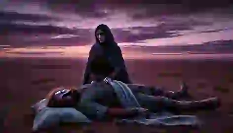 Bayan-Sulu mourns beside the gravely wounded Kozi-Korpesh at twilight, their love persisting even in grief.