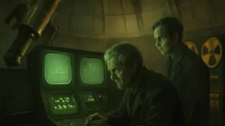 A glowing mainframe console with lines of code reflecting on the faces of attentive programmers